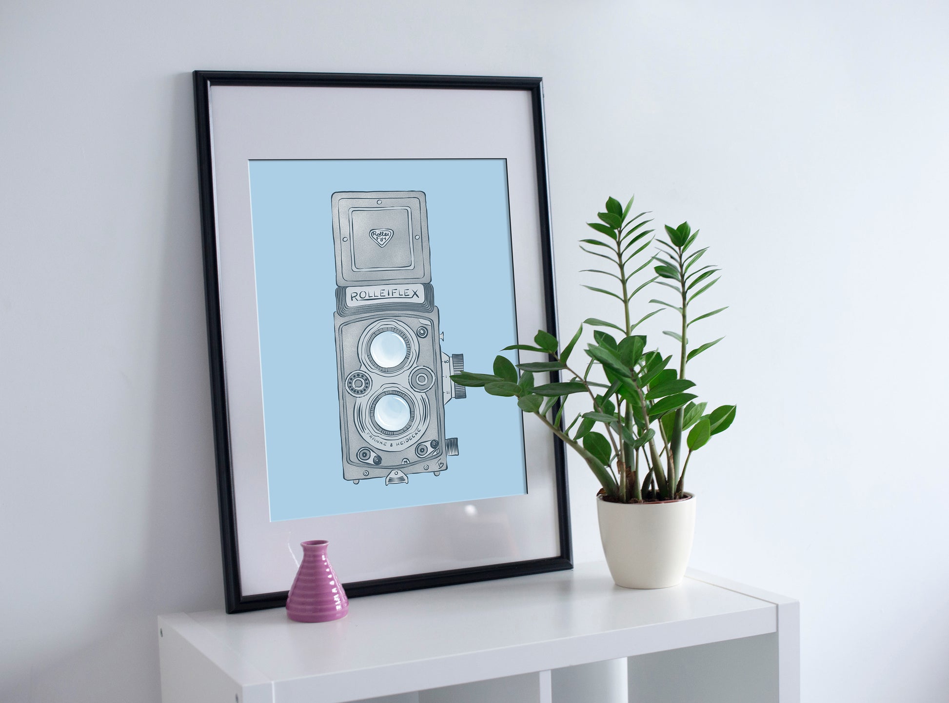 Illustration of vintage photography camera, rolleiflex model with two lenses and top viewfinder.  The camera is in medium to light gray tones, on a plain light blue background 